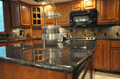Maple Cabinets with Slate Backsplash and Uba Tuba Granite